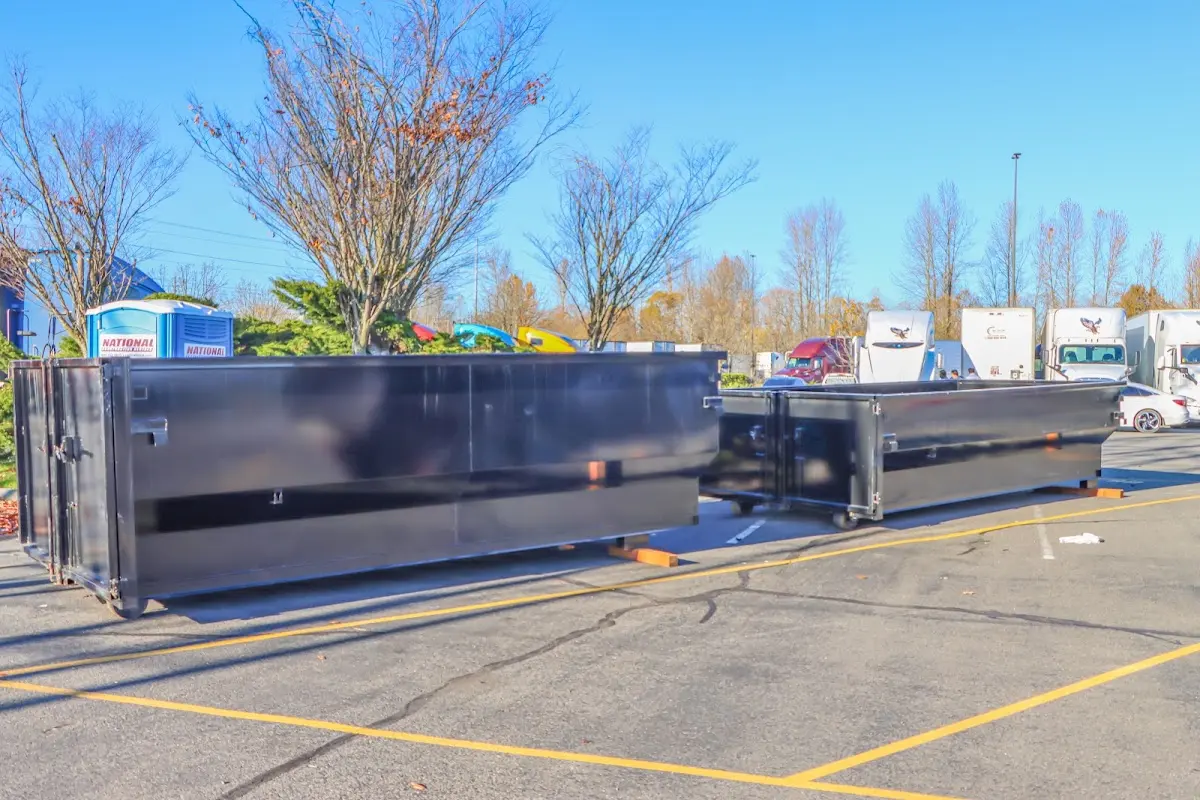 Professional dumpster rental service with roll-off container on residential driveway in Panama City Beach